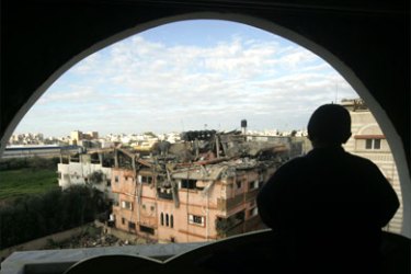 A Palestinian youth looks at a destroyed house following an Israeli air strike in the Nusseirat refugee camp in central Gaza Strip on January 3, 2009