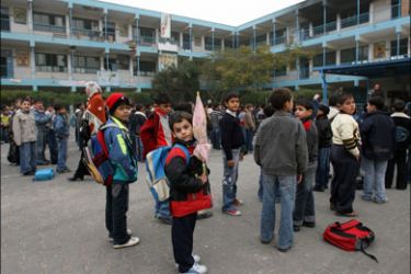 afp : Palestinian schoolboys stand in line following recess at a school run by UNRWA, which was hit by an Israeli air strike on January 17, in Beit Lahia in the northern Gaza Strip on