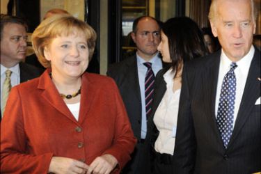 afp : German Chancellor Angela Merkel and US Vice-President Joe Biden talk at the Bayerischer Hof hotel, the venue of the Munich Security Conference, in Munich,