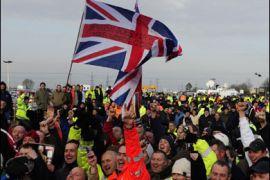 r/Workers pose for members of the media outside the Total Lindsey refinery, near Grimsby northern England February 4, 2009.