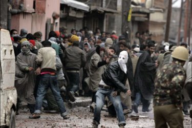 afp : Kashmiri protesters throw stones towards a Jammu Kashmir police vehicle during a protest in Srinagar February 20, 2009. At least 26 people were injured when Indian police