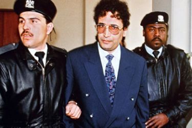 afp/ (FILES) A file picture dated February 18, 1992, shows convicted Lockerbie bomber, Libyan Abdelbaset Ali Mohmet al-Megrahi (C), being escorted by security officers in Tripoli. Megrahi, who is serving a life sentence with a minimum term of 27 years in a British prison for downing a transatlantic US airliner over the Scottish village of Lockerbie in 1988, killing 270 people, is in danger of dying due to deteriorating cancer, his wife said on February 26, 2009.