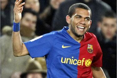 REUTERS / Barcelona's Dani Alves celebrates a goal against Sporting Gijon during their Spanish first division soccer league match at Camp Nou stadium in Barcelona, February 8, 2009.
