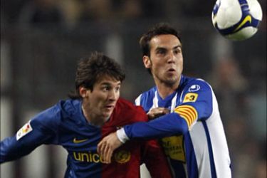 r_Barcelona's Lionel Messi (L) fights the ball against Espanyol's David Garcia during their Spanish first division soccer league match at Camp Nou stadium in Barcelona