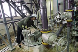 f_A file picture dated April 3, 2007 shows a female Russian technician checking equipment inside the Bushehr nuclear power plant, in the Iranian Persian Gulf port