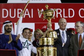 r : Trainer Eoin Harty (R), jockey Aaron Gryder (2nd L) and William Casner (2nd R), owner of Well Armed from the U.S., receive the Dubai World Cup trophy from Sheikh Mohammad