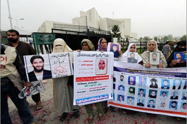 AFP - Pakistani women hold pictures of their missing relatives outside the Supreme Court building in Islamabad on March 24, 2009. Pakistani Supreme Court Chief Justice Iftikhar Muhammad Chaudhry ordered security services to produce several of the missing in court before he was sacked by