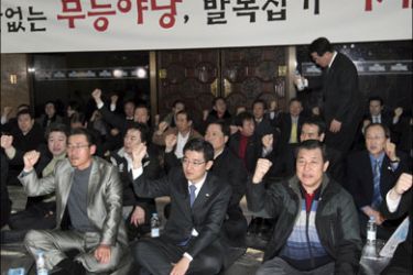epa : epa01652491 Grand National Party officials sit at the entrance of the National Assembly's main conference hall in Seoul, South Korea, 02 March 2009, as the party stages a sit-