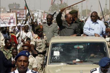 afp ; Sudanese President Omar al-Beshir (car-C) waves to supporters during his visit to the North Darfur state capital of el-Fasher on March 8, 2009. A defiant Beshir, on his first visit