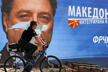 A cyclist rides his bike as he passes a large election billboard of the opposition SDSM party Ljubomir Frckoski in Skopje on April 4, 2009. Macedonians will cast ballots