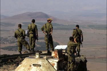 afp : FILES) -- File picture dated September 7, 2007 shows Israeli army officers looking towards Syria from the Mount Bental observation post in the occupied Golan Heights. The