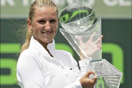 r : Victoria Azarenka of Belarus poses with the winner's trophy after defeating Serena Williams of the U.S. in the women's singles final at the Sony Ericsson Open tennis