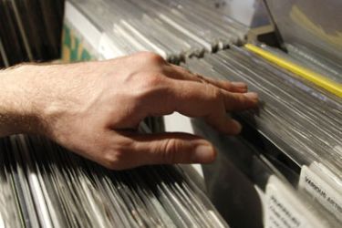 A man flicks through records in the Phonica record store on Record Store Day, in central London April 18, 2009. The day aimed to celebrate independent record stores.