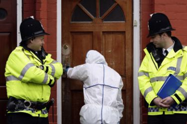 A forensic officer enters a house on Galsworthy Avenue in Manchester, northern England April 9, 2009. Britain's most senior counter-terrorism officer Bob Quick quit