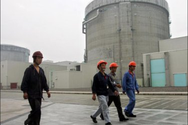 afp : (FILES) This file photo taken on June 10, 2005 shows workers at the Qinshan Nuclear Power Plant walking past containment structures housing nuclear reactors in Qinshan,