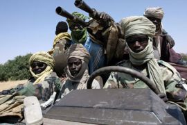 afp/ (FILES) -- File pictures dated October 17, 2007 shows fighters of the Sudanese Justice and Equality Movement (JEM) driving their armoured battle wagon at an unknown location on the Sudan-Chad border in northwest Darfur.