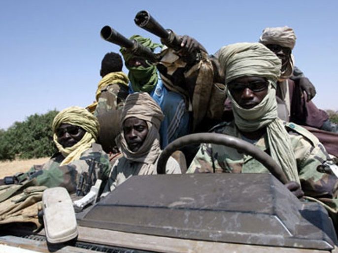 afp/ (FILES) -- File pictures dated October 17, 2007 shows fighters of the Sudanese Justice and Equality Movement (JEM) driving their armoured battle wagon at an unknown location on the Sudan-Chad border in northwest Darfur.