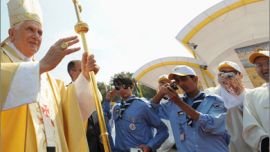 Pope Benedict XVI blesses the crowd before celebrating mass at Amman's open-air football stadium on May 10, 2009