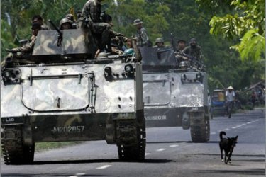 Philippine Army armoured personnel carriers and trucks move down a highway of the town of Datu Piang after separatist Moro Islamic Liberation Front (MILF) rebels bombed a bridge in the area on May 26, 2009.