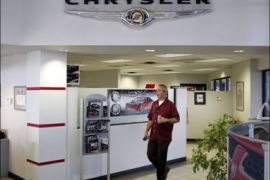 r : A salesman walks through the showroom of Performance Chrysler Jeep Dodge dealership in Phoenix, Arizona May 16, 2009. Chrysler filed for bankruptcy on April 30 and plans to