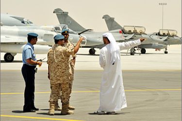 AFP - Emirati military personnel stand near two French jet fighters Rafales and an Emirati Mirage 2000-9 at a military base near Abu Dhabi on May 25, 2009. French President Nicolas Sarkozy travels to Abu Dhabi on May 25 to open France's first permanent military base in the Gulf, giving it a strategic role in a region roiled by Iran and a key supply route for oil.