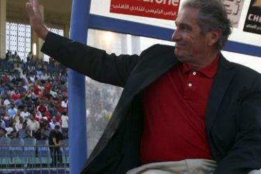Portuguese coach Manuel Jose waves to fans of Al-Ahly during their Confederation of African Football (CAF) Cup soccer match against Angola Santos FC at the Military Stadium in Cairo