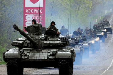 afp : Georgian tanks move in convoy along a road outside Tbilisi on May 5, 2009. A military mutiny in the former Soviet Republic of Georgia appears to be "a somewhat isolated