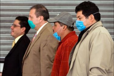 afp : Some people wear surgical masks at Benito Suarez International Airport in Mexico City on May 5, 2009. The impact of A(H1N1) influenza (swine flu) cost Mexico's