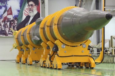 An Iranian missile that state media says is the surface-to-surface Sejil 2 missile is seen in front of a banner with a picture of Iran's Supreme Leader Ayatollah Ali Khamenei, at an unknown place in Semnan,