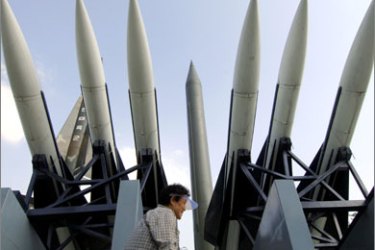 This file photo taken on October 5, 2006 shows a South Korean woman walking past a display of a North Korea's Scud-B missile (C) and other South Korean missiles at the Korea War Memorial Museum in Seoul