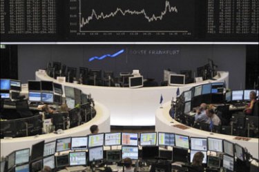 r : Traders work at their desks in front of the DAX board at the Frankfurt stock exchange June 2, 2009. REUTERS/Remote/Wolfgang Rattay (GERMANY