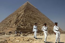Egyptian policemen survey the grounds of the Cheops pyramids in the Giza plateau in the outskirts of Cairo where security is heightened on June 2, 2009, in preparation for the
