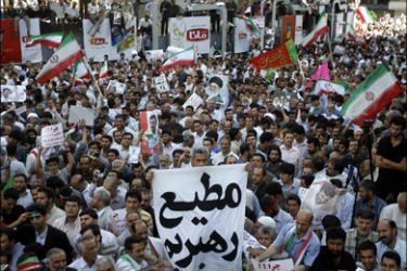 afp : Supporters of Iranian President Mahmoud Ahmadinejad wave national flags and other banners and portraits during a rally held in Tehran's Vali Asr square on June 16, 2009. The