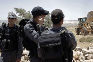 Israeli police stand guard as they tear down the Jewish Migron wildcat outpost near the occupied West Bank city of Ramallah on May 3, 2009