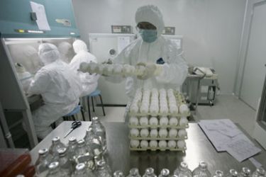 A technician holds a tray of eggs in the inoculation area of Sinovac Biotech Ltd., a Chinese vaccine making company, during production of a vaccine for the H1N1 flu virus in Beijing