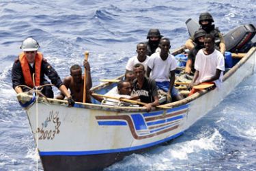 Marines from NATO's Portuguese frigate Corte-Real arrest suspected pirates on their skiff in the Gulf of Aden June 22, 2009. Eight Somali pirates armed with rocket-propelled