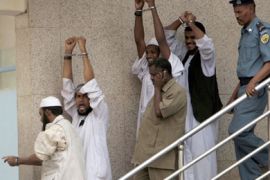 Four Islamists (2nd R, 3rd R, 1st L, 2nd L) accused for the 2008 killing of a US diplomat and his Sudanese driver raise their hands and shout slogans after a court issued