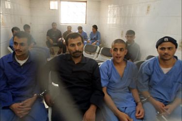 r_Suspected Shiite rebels sit behind bars during the first hearing into their case at a state security court in Sanaa June 6, 2009. The suspects are charged with battling government