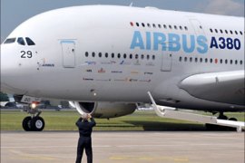 A pilot takes pictures of an Airbus A380 as the plane prepares to take off to practice its flight routine on June