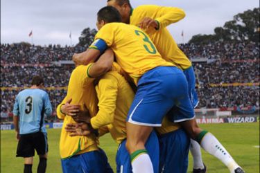 afp - Brazil's defender Juan (bottom) celebrates his goal against Uruguay with teammates during thieir FIFA World Cup South Africa-2010 South American qualifier football