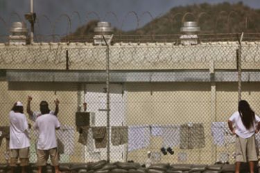 In this pool photo, reviewed by the U.S. military, Guantanamo detainees talk together inside the open-air yard at Camp 4 detention facility at Guantanamo Bay U.S. Naval Base, Cuba,