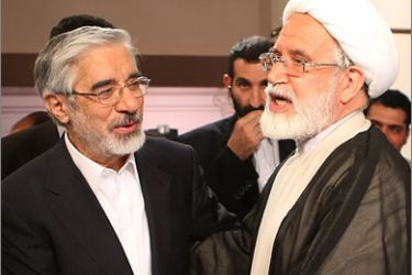 Iran's presidential candidate Mir Hossein Mousavi (L) shakes hands with reformist candidate Mehdi Karroubi (R) following their debate in Tehran on late June 7, 2009
