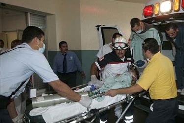 r_Paramedics wheel a baby to an emergency room after being rescued from a fire at a daycare center in Hermosillo, Mexican state of Sonora June 5, 2009