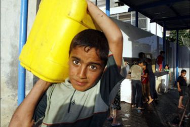 afp : A Palestinian boy carries a water container after filling it from a water purification station in Khan Yunis in the southern Gaza Strip on June 9, 2009. Israel is facing growing