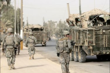 afp : US soldiers of the 1st battalion, 5th Infantry Regiment, 1st Stryker Brigade Combat Team, walk the streets following a ceremony of transfer from the US military to the Iraqi