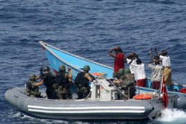 Marines from NATO's Turkish frigate Gediz arrest suspected pirates on their skiff in the Gulf of Aden July 31, 2009. Turkish navy commandos taking part in a NATO mission to combat