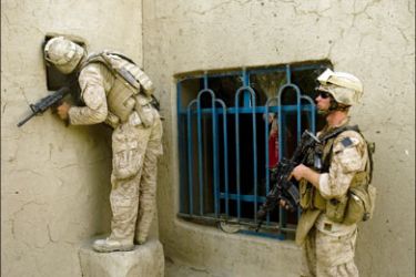 afp : US Marines of 1st Combat Engineering Battalion of 2nd Marine Expeditionary Brigade search a compound in the Garmsir district of Helmand Province on July 12, 2009. Four