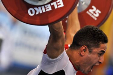 Egyptian Mohamed Abdelbaki lifts in Men's 69 kg Snatch category at the XVI Mediterranean Games in Pescara on June 27, 2009. Dabaya-Tientcheu won the gold