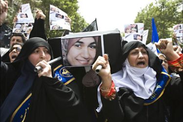 Worshippers carry a symbolic coffin of Marwa El-Sherbiny