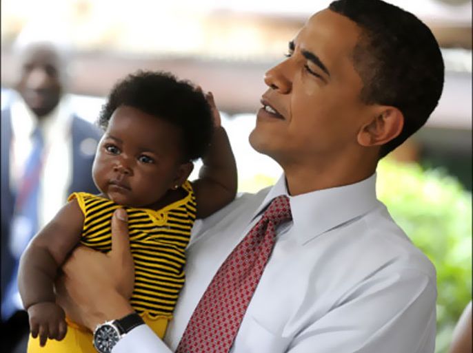 epa : epa01791323 US President Barack Obama holds a child while participating in a maternal health program tour at LA General Hospital in Accra, Ghana 11 July 2009. President